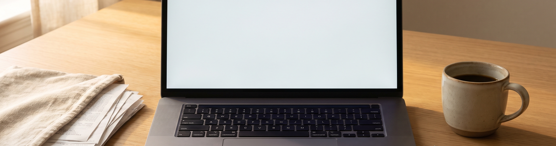 Laptop und Belegstapel auf dem Schreibtisch zur Steuererklärung