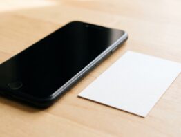 Ausgeschaltetes Smartphone neben einem leeren Kartenrohling