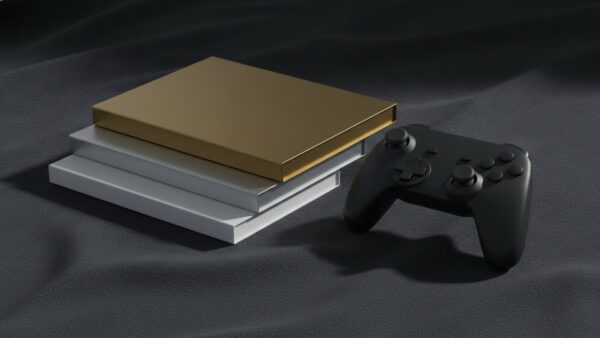 Drei unbeschriftete Spielehüllen in Weiß, Silber und Gold neben einem Gamecontroller