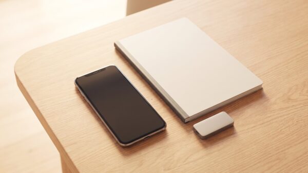 Smartphone, geschlossenes Notebook und externes Speichergerät
